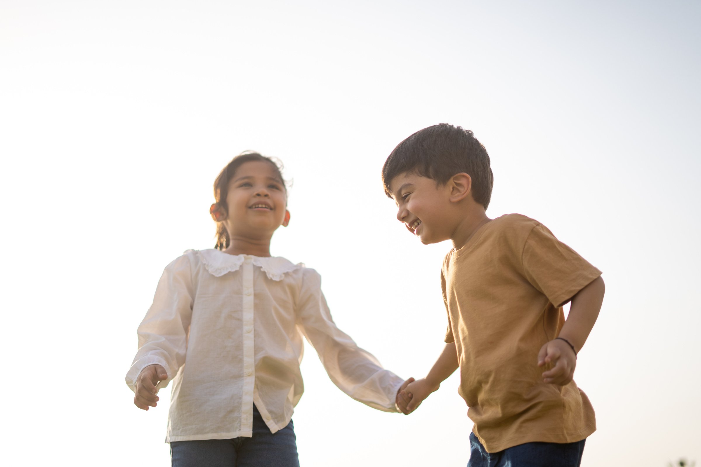 Happy Little Boy and Girl Outdoors